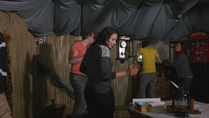 Team of four members looking for clues for escaping in escape room game