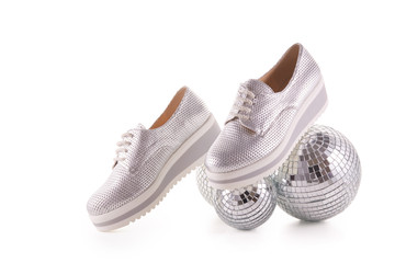 Silvery sneakers on white background..
