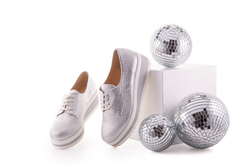 Silvery sneakers on white background..