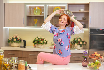 girl with red hair sitting in the kitchen