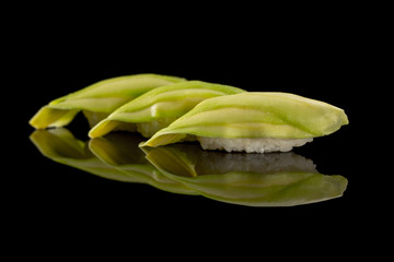 nigiri with cucumber - sushi set on the black background © mateusz