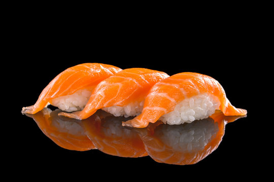 salmon nigiri sushi on the black background