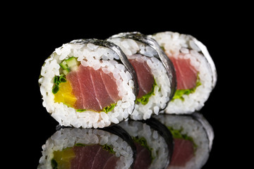 sushi rolls on the black background