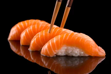 Keuken spatwand met foto salmon nigiri sushi on the black background © mateusz