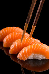 salmon nigiri sushi on the black background