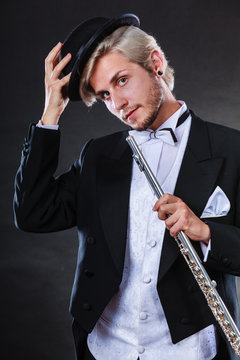 Elegantly dressed musician holding flute