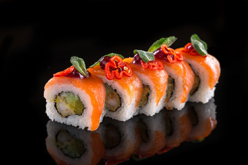 sushi rolls on the black background
