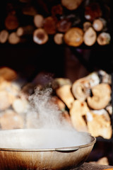 Closeup photo of steaming pot with food heated on fire