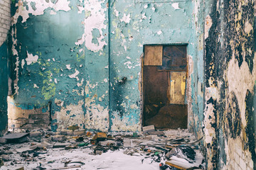 Closed door in a dirty ruined room