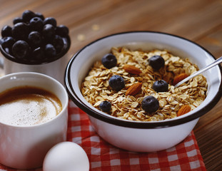 A healthy breakfast - Oatmeal porridge, boiled egg, milk, fresh berries and coffee. A great start to a new day.