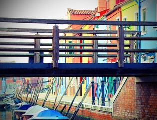 Bridge over the waterway near the houses of the island of Burano  with vintage effect