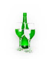 Still life with a green bottle and two glasses of water on a white background.