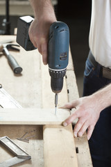 carpenter using electric drill