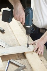 carpenter using electric drill