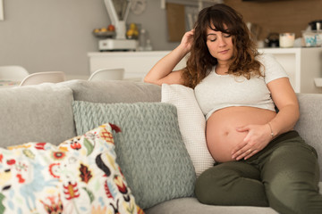 Pregnant woman touching her belly