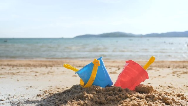 Toys on the sand beach with sea wave select focus shallow depth of field with summer atmosphere