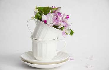 white cups spring flowers on a table