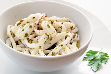 boiled calamari rings marinated in lemon juice and olive oil with garlic and parsley