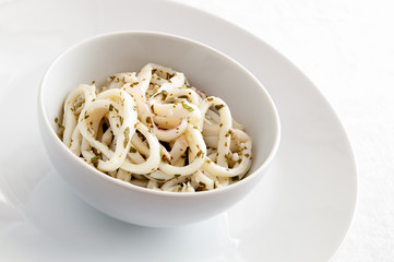 calamari marinated in lemon juice and olive oil with garlic and parsley