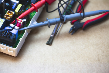 Repair Work Of Electronic Circuit Bord With Oscilloscope Probe Connect To Device For Measuring The Signal.