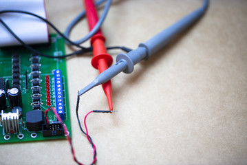 Repair Work Of Electronic Circuit Bord With Oscilloscope Probe Connect To Device For Measuring The Signal.