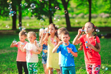 Group of children blowing soap bubbles