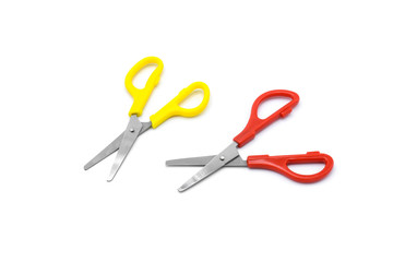 yellow and red plastic scissors isolated on white background