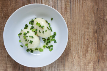 Top view of potato noodles with meat on the white plate