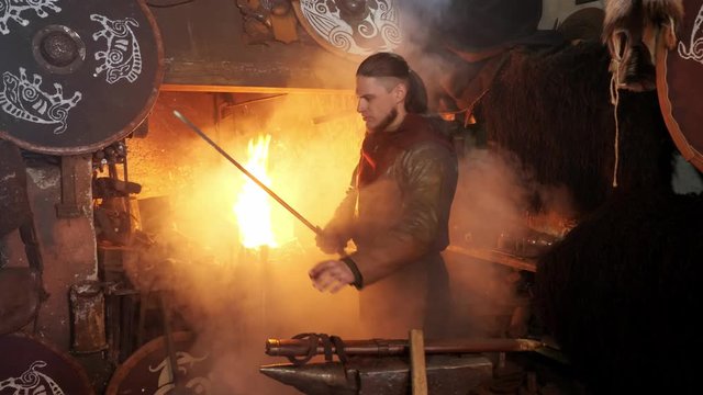 The medieval viking taken sword to examine metal of sword