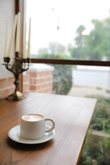 cappuccino or Latte art coffee made from milk on the wood table in coffee shop