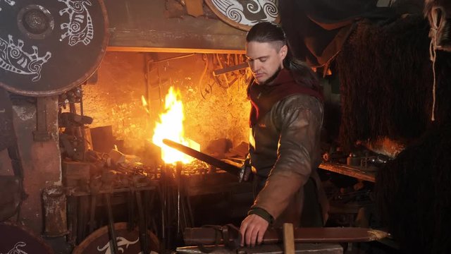 The medieval viking taken sword to examine metal of sword