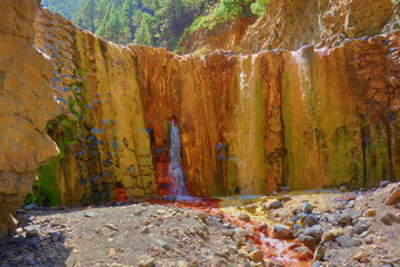 Cascada de Colores - Picturesque dam for rainwater in a volcanic crater, which was colorfully colored by mineral water, Caldera de Taburiente, La Palma, Canary Islands, Spain © Tom
