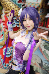 Fototapeta na wymiar Portrait of asian young woman with purple Chinese dress cosplay with temple