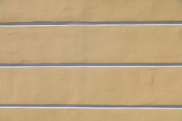 Obraz premium Warm yellow rough with crack wall texture with horizontal white profound lines background for design 