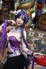 Portrait of asian young woman dancing with purple Chinese dress cosplay with temple