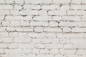 old wall from a white brick with a regular laying. horizontal direction