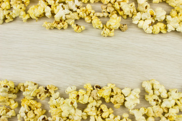 Popcorn on wooden desk. Empty space for text and design
