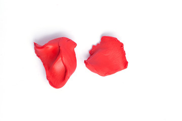 Red pieces of plasticine on a white background.