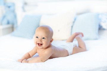 Baby boy on white bed