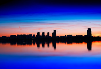 Obraz na płótnie Canvas Skyscrapers meeting burning sunset background