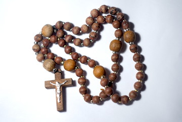 wooden rosary beads on light background