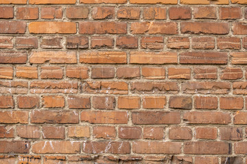 Old house wall of red destroyed bricks