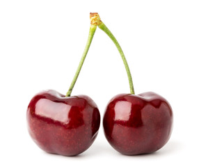Two ripe red cherries on a white isolated.