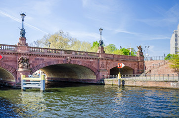 Obraz premium Moltke Bridge over the Spree River with griffons, arms and lantern in Berlin, Germany