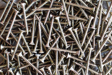 Closeup of metal screws as construction and repair background.