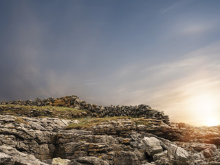 Traditional Irish dry stone fence on a hill, sunset time.