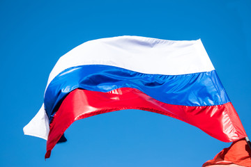 The government flag of Russian Federation or Russia on the sky background.