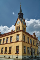 Fototapeta na wymiar historic town hall with a clock tower on the market square in the city of Vidnava in the Czech Republic.