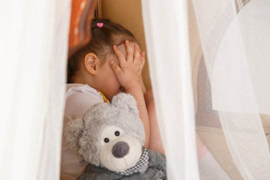 Little Kid Hiding Behind Teddy Bear