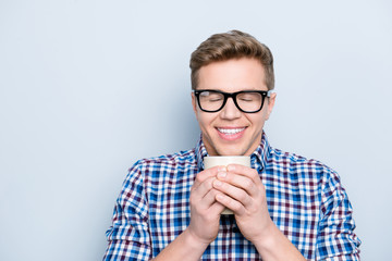 Aromatic university person delight pleasure concept. Close up portrait of rejoicing funny funky cheerful joyful cute lovely guy drinking fresh tasty coffee isolated on gray background copy-space